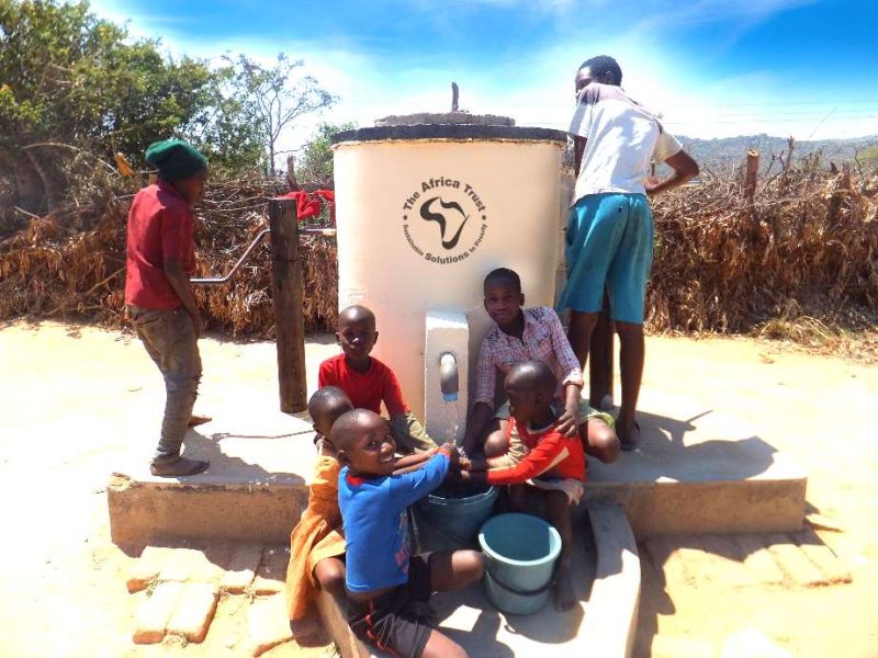 #AT Logo - E - Group of children pumping water